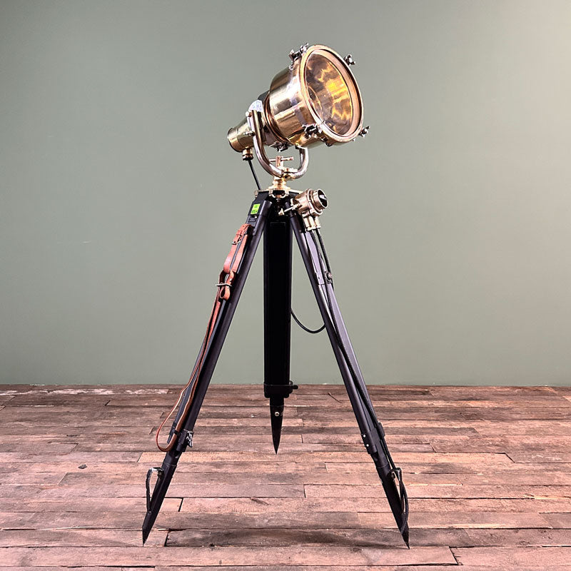 vintage brass searchlight on black tripod with industrial style switch, fully restored and in perfect working condition