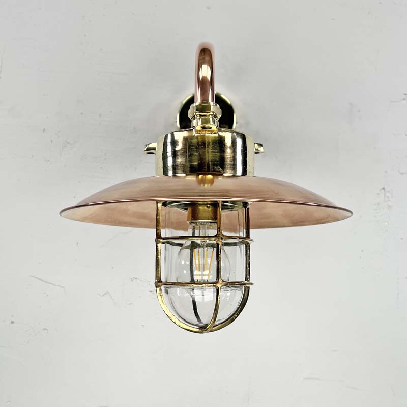 The copper cage wall light is a reclaimed original industrial explosion proof brass lamp. Full of industrial style with a protective brass cage, copper shade and copper wall arm this wall lamp is beautifully restored for modern interiors.&nbsp;