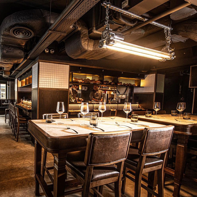 vintage industrial strip light with Edison LED tubes hanging in an industrial style bar restaurant. 