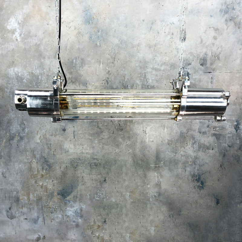 Shop for a vintage strip light in aluminium with a flameproof glass tube enclosure. Fitted with dimmable LED filament tubes. Vintage industrial ceiling lighting restored & reclaimed ready to for modern interiors