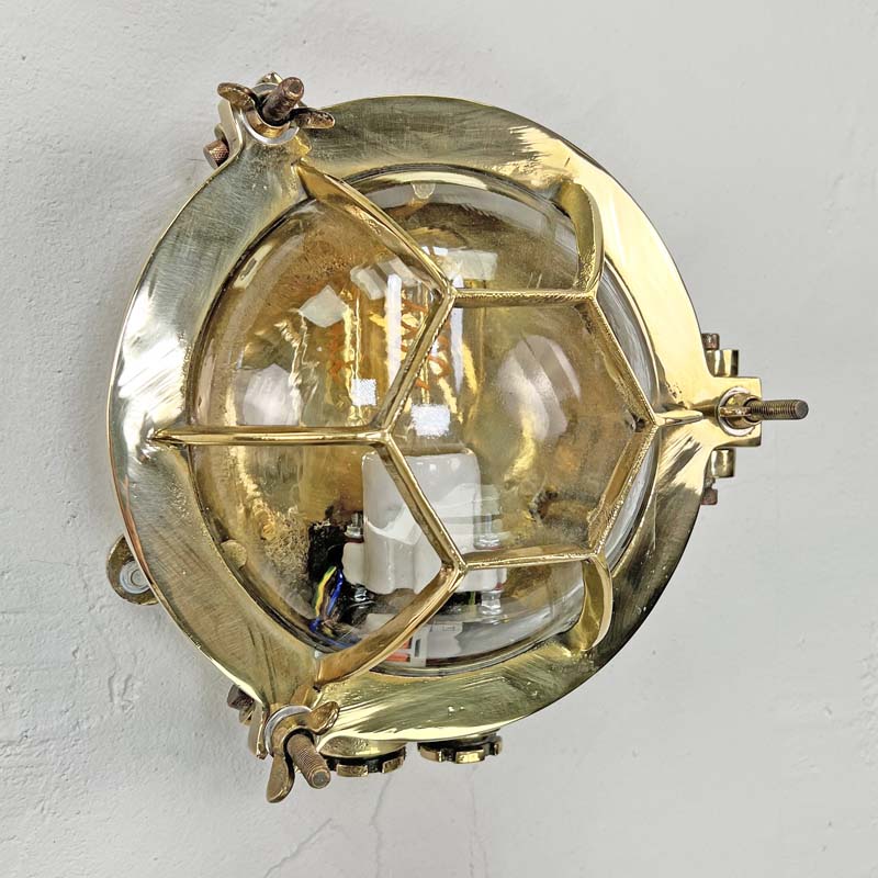 Solid brass bulkhead light with a protective hexagonal cage. These original vintage industrial wall lights are reclaimed from marine settings and professionally refurbished and rewired by hand in our workshop ready for indoor use. 