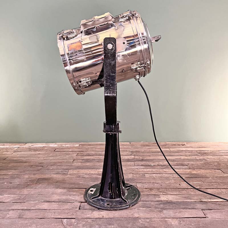 a large stainless steel searchlight on a heavy duty black steel floor stand. A large industrial style floor lamp made in 1983 in Japan and used on cargo ships. Reclaimed and restored ready for modern interiors