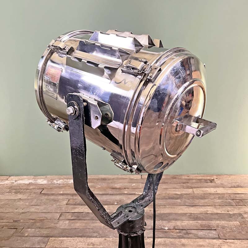 a large stainless steel searchlight on a heavy duty black steel floor stand. A large industrial style floor lamp made in 1983 in Japan and used on cargo ships. Reclaimed and restored ready for modern interiors