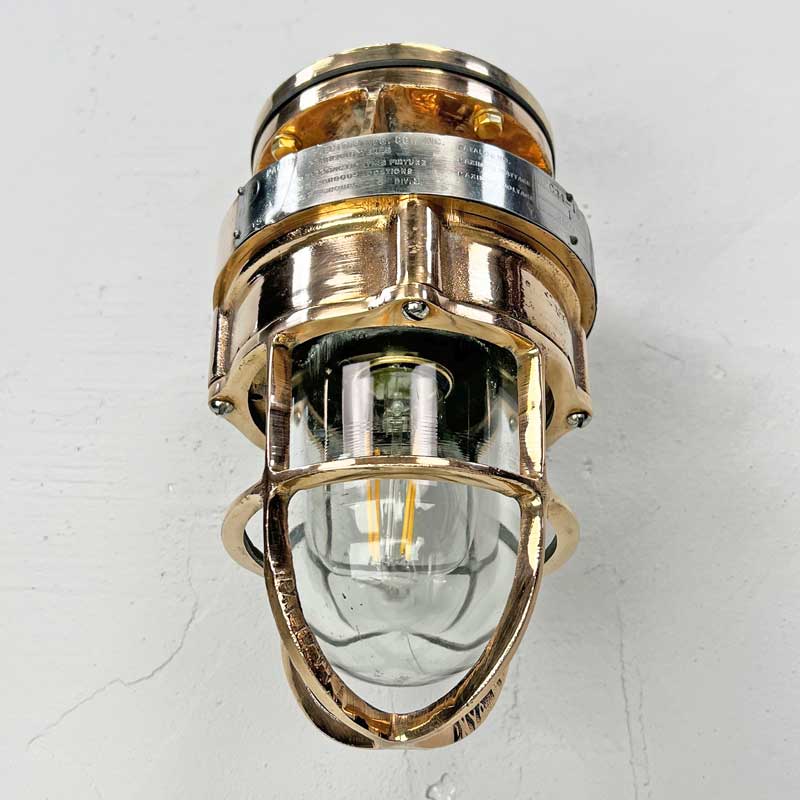 A robust bronze industrial outdoor light reclaimed from decommissioned cargo ships. This is a vintage industrial wall light made by the American company Pauluhn Electric Manufacturing.&nbsp;We have professionally restored this wall light so they are ready to install outdoors and use with LED light bulbs. Or use indoors for authentic industrial look & feel.
