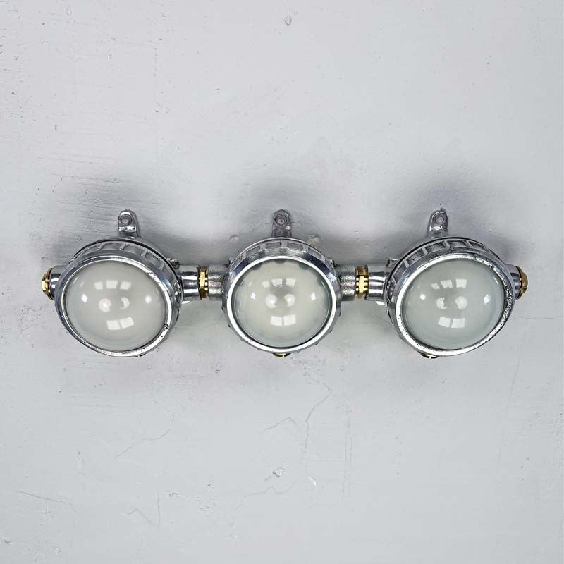 Shop unusual wall lights at Loomlight, restored vintage industrial lighting. This quirky trio of industrial spotlights has frosted glass and compatible with LED bulbs. 