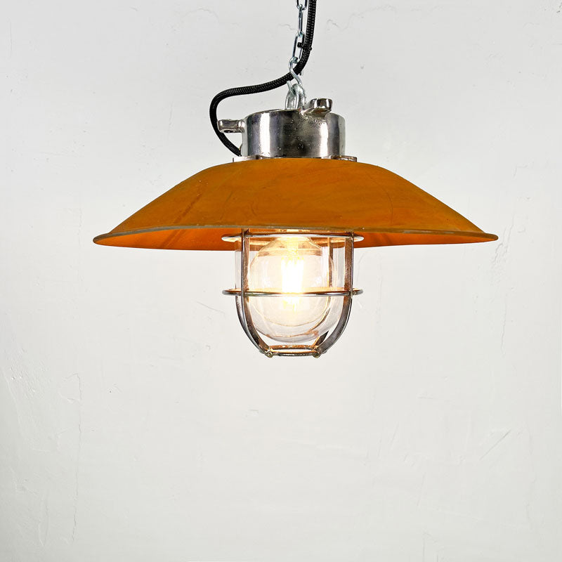 a rusted cage pendant light by Kokosha. A vintage industrial steel pendant light with a protective cage and shade.Ideal kitchen island lighting for rustic kitchens
