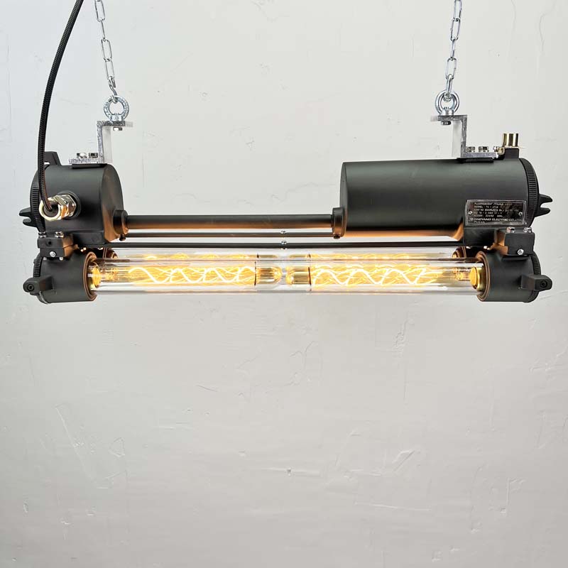 This vintage black pendant light is refurbished with dimmable Edison LED tubes and finished in matte black paint creating a beautifully restored original industrial strip light.