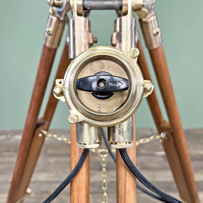 Shop the brass daylight signal lamp. A morse code light reclaimed from Navy ships. Paired with a Stanley of London tripod to create a bespoke signal light tripod floor lamp. 