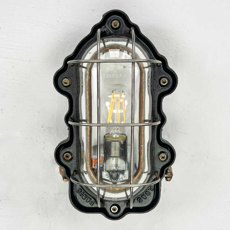 Vintage industrial indoor bulkhead light by Perfeclair, made in cast steel painted black with a protective cage over the lampholder. Fully rewired and restored ready for modern interiors.