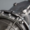 Close-up of a metal object with engraved text on a gray background