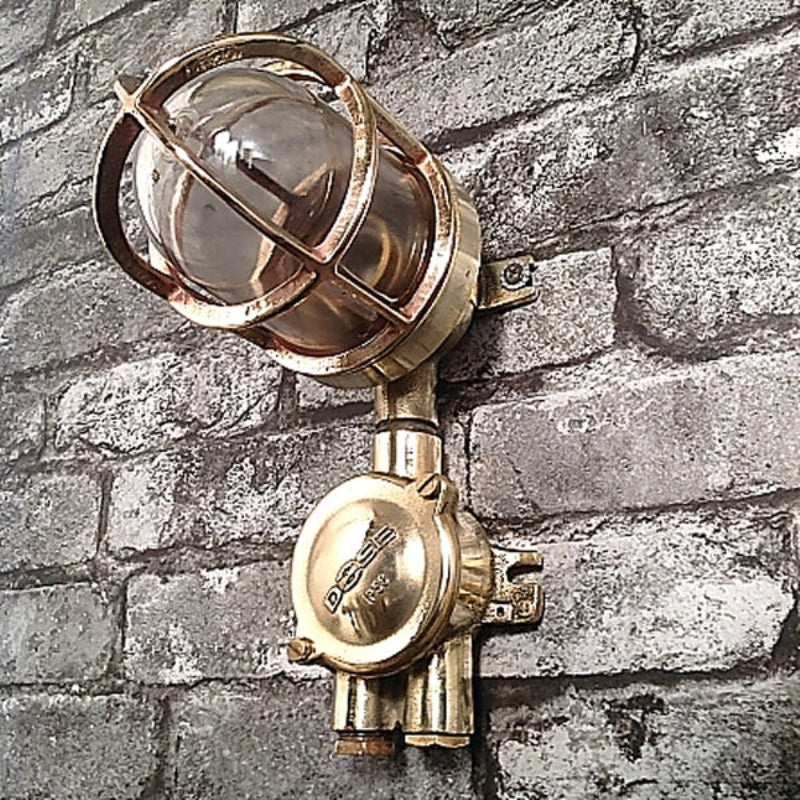 A reclaimed military brass 90 degree wall light with cast brass cage. reclaimed from military vessels and rewired compatible with LED light bulbs. 