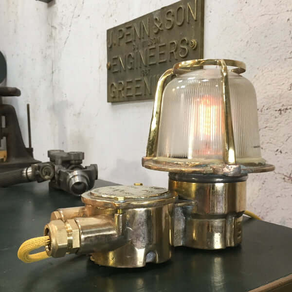 A reclaimed retro industrial brass table lamp converted from an old brass bulkhead lamp by EOW