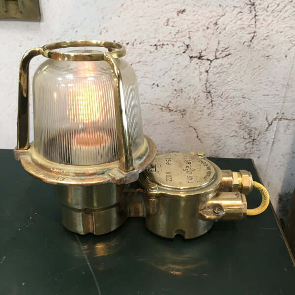 A reclaimed retro industrial brass table lamp converted from an old brass bulkhead lamp by EOW