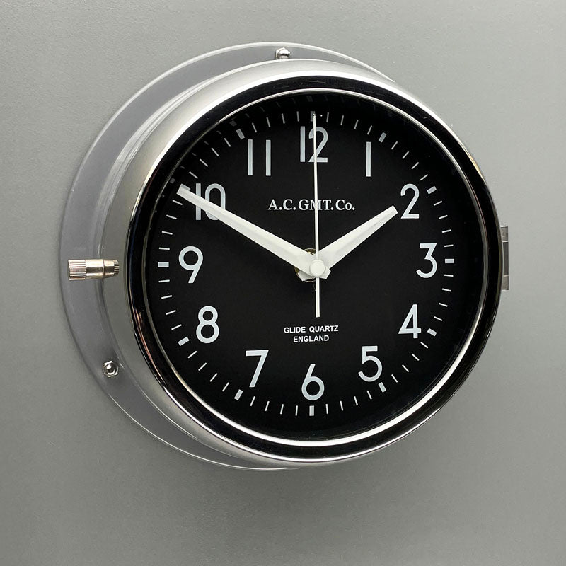 Silver wall clock with black face and white digits. This original nautical wall clock features a quartz silent sweep seconds hand movement meaning no ticking! a timeless and silent wall clock suitable for any contemporary interior.