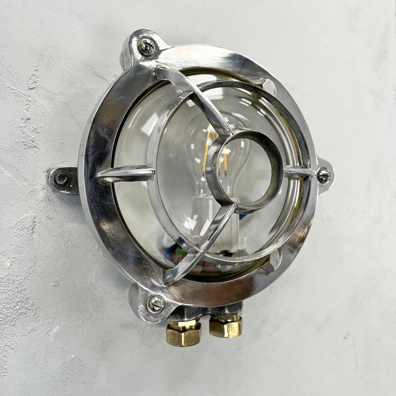 Vintage industrial aluminium circular wall light with target cage. Reclaimed round bulkhead lights restored suitable for outdoor or indoor use. 