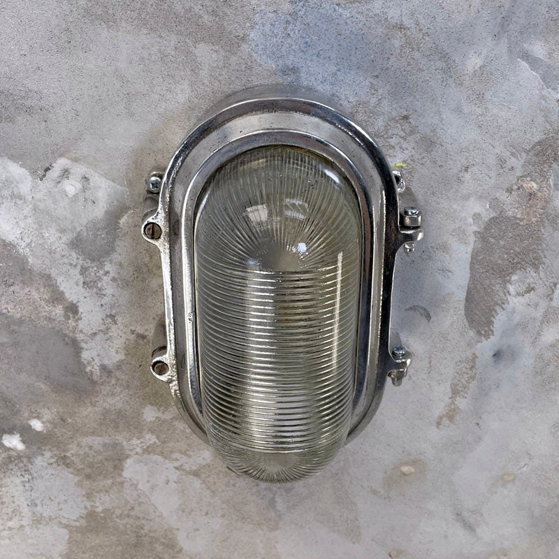 Vintage bulkhead lights with prismatic glass cover and aluminium case. An industrial style bulkhead for wall or ceiling.