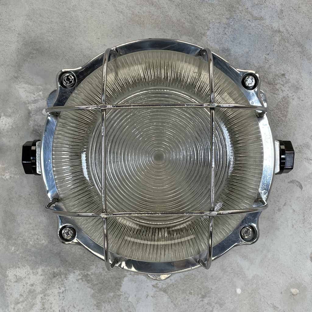 Vintage industrial circular aluminium bulkhead wall light with prismatic glass and protective cage