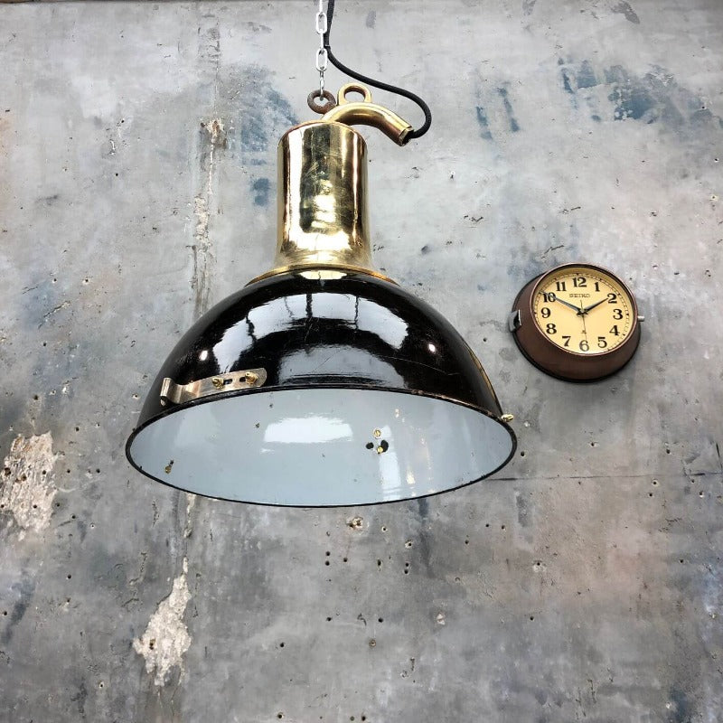 A brass and black enamel reclaimed industrial ceiling pendant.