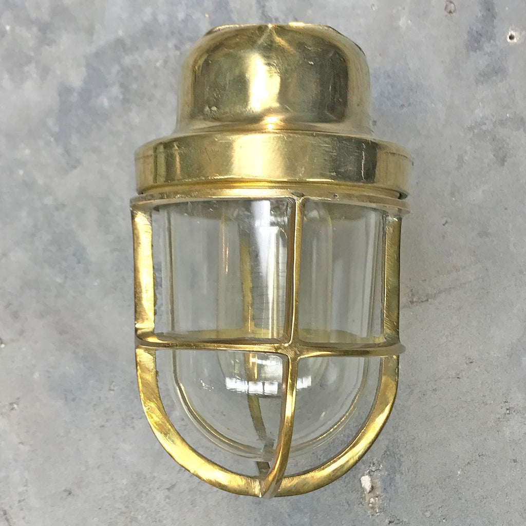 A reclaimed retro industrial solid brass 90 degree outdoor wall light with protective cage. 