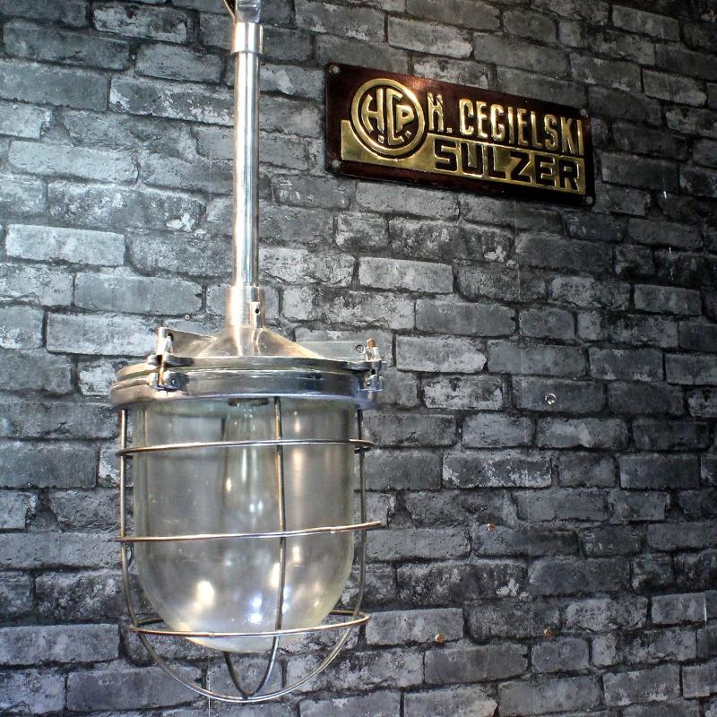 An industrial style clear glass dome ceiling pendant cage light. 