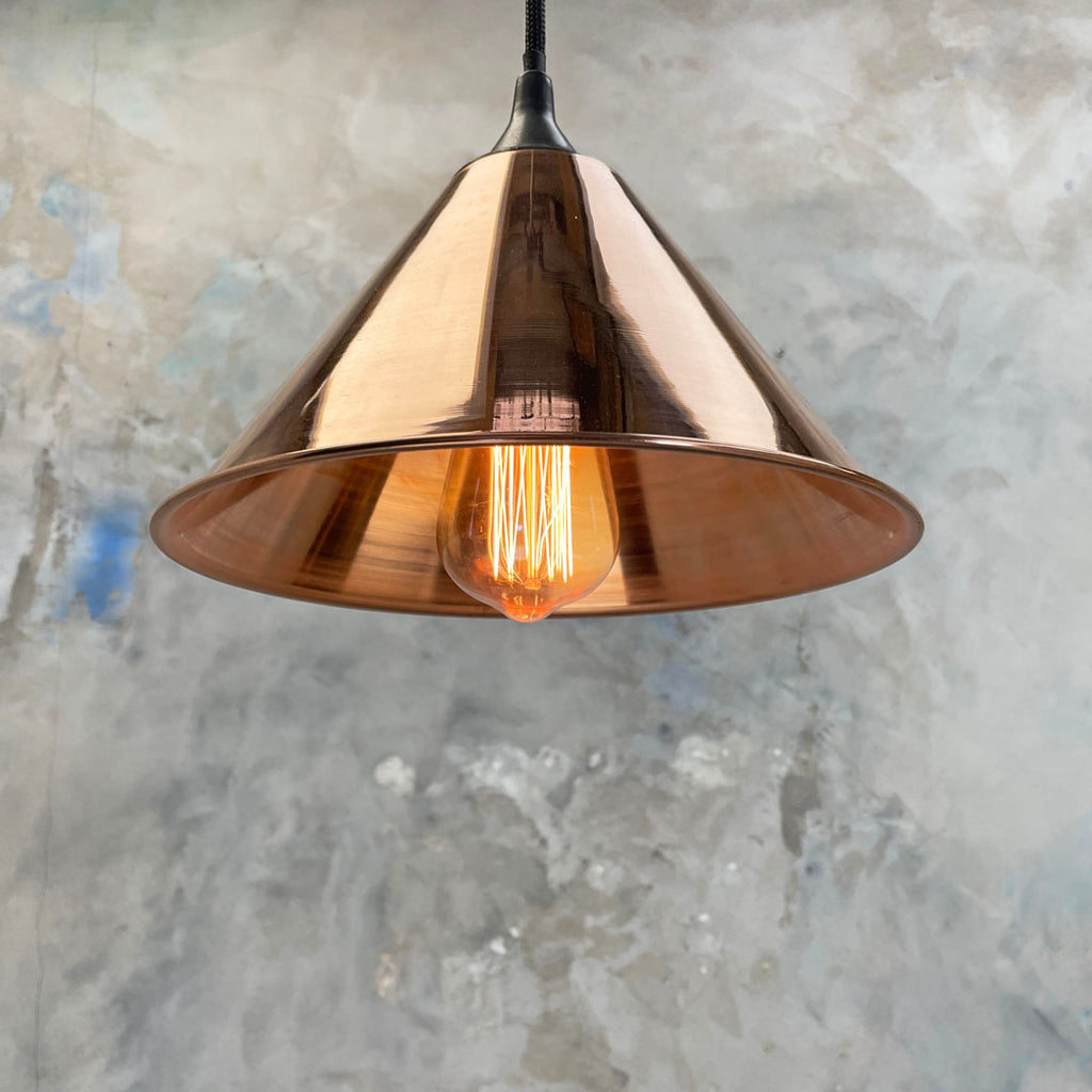 Small copper conical pendant lighting with Edison LED Filament light bulb. Great dining table lighting