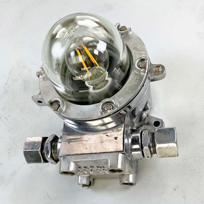 A highly robust flameproof vintage aluminium nautical wall light. Reclaimed from decommissioned cargo ships and fully refurbished by hand. Compatible with LED light bulbs.
