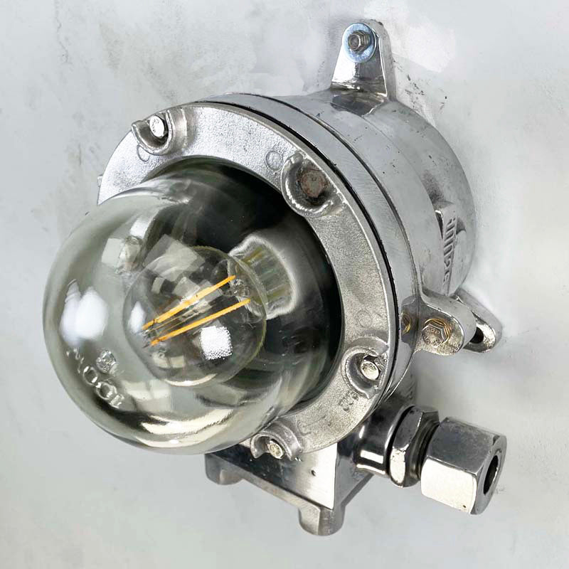A highly robust flameproof vintage aluminium nautical wall light. Reclaimed from decommissioned cargo ships and fully refurbished by hand. Compatible with LED light bulbs.