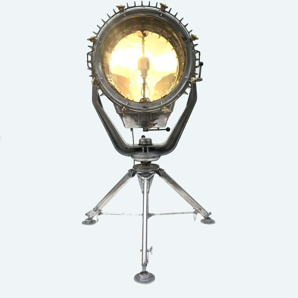 A reclaimed retro industrial aluminium marine searchlight paired with a satellite tripod to create a large bespoke floor lamp.