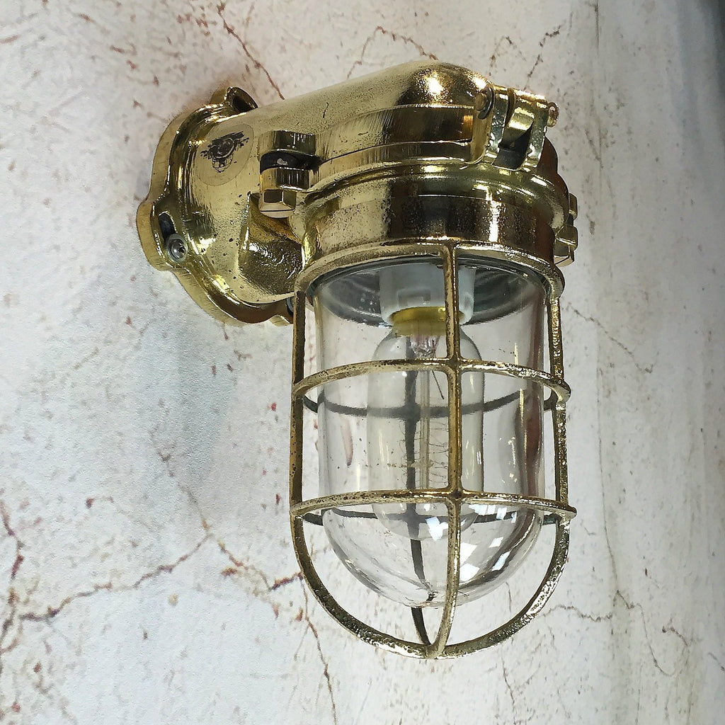 A Japanese industrial brass 90 degree wall light with cage
