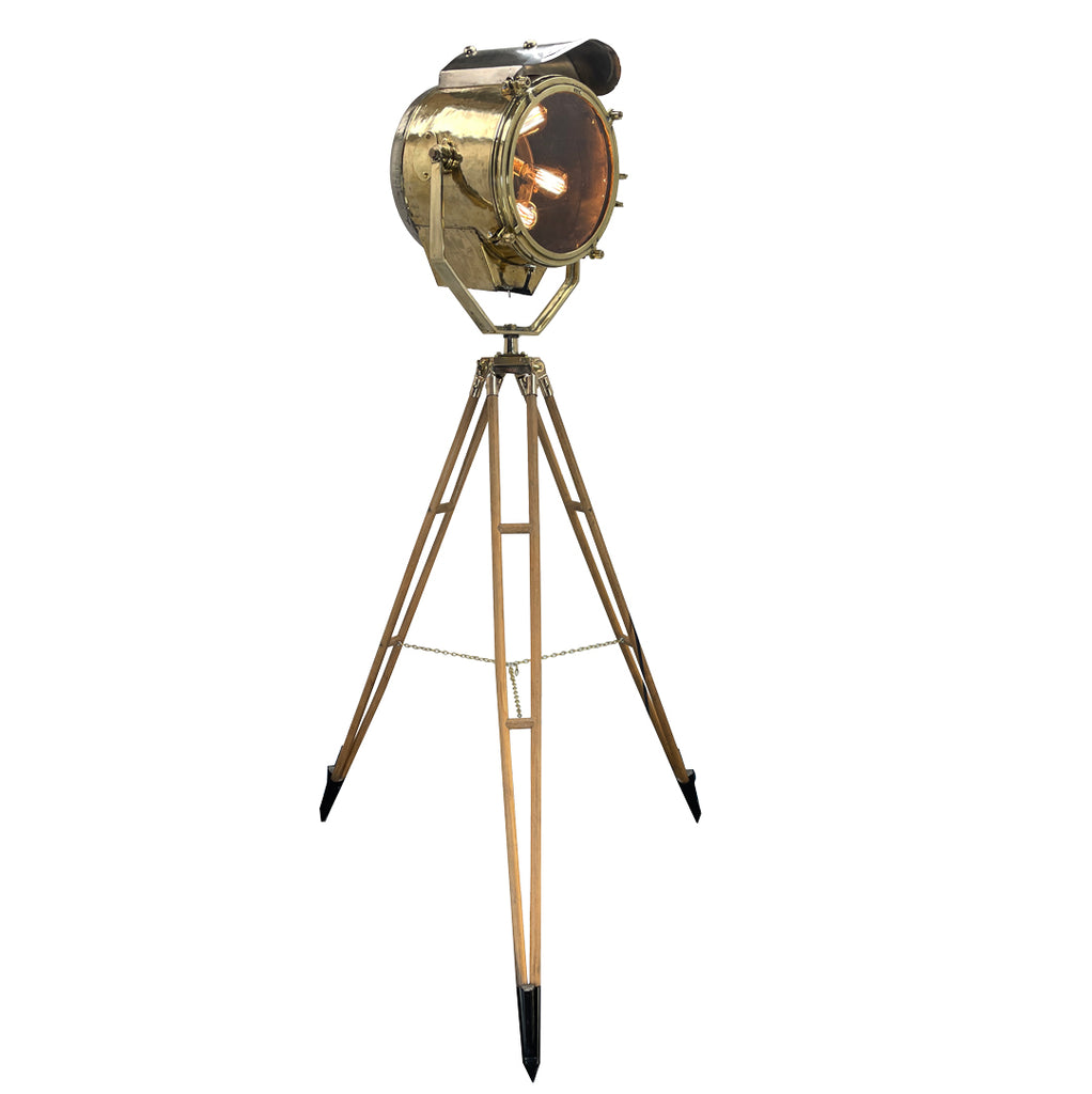 A tall nautical brass and steel searchlight mounted onto a British antique wooden surveyors tripod. A unique and original tall tripod floor  lamp perfect for creating the "wow" factor with a nautical style fixture. 
