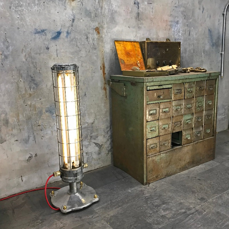 Vintage industrial floor lamp with cage . This is an industrial style floor standing tube light 