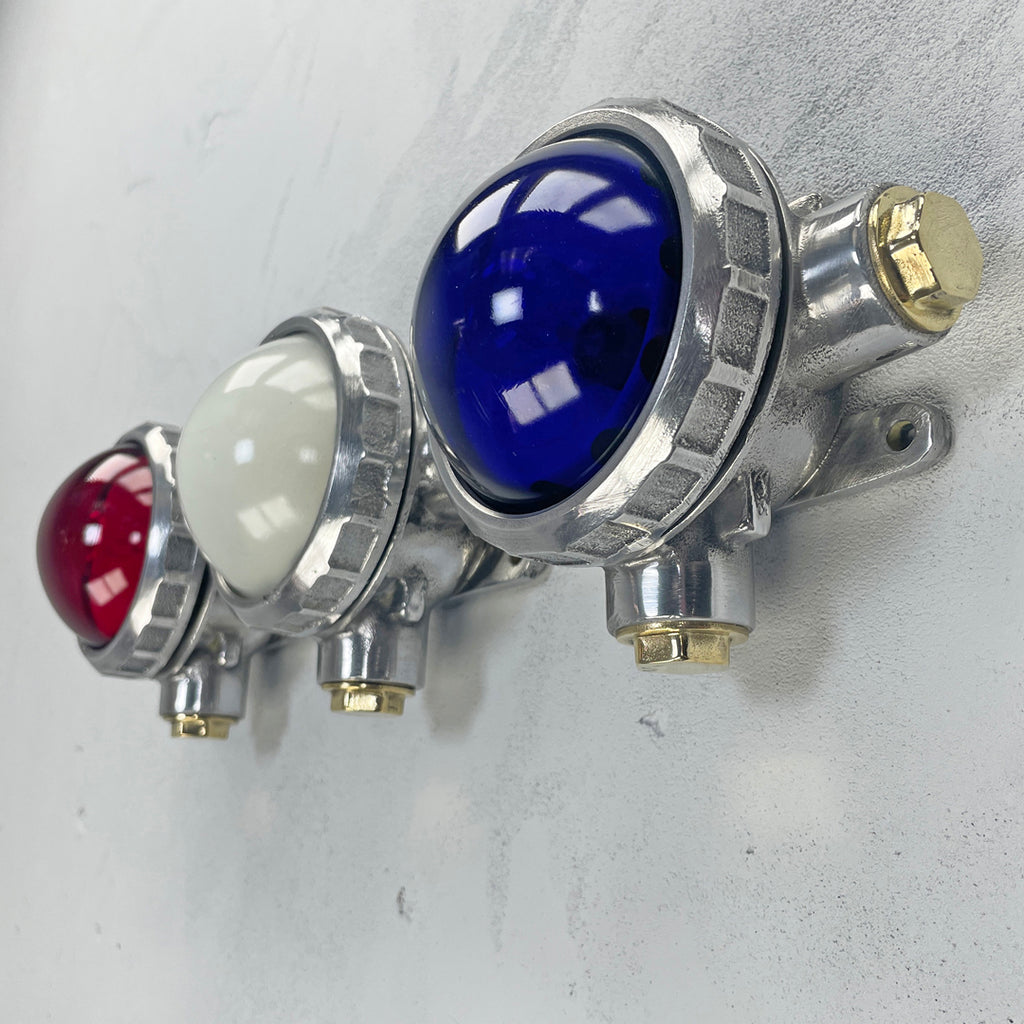 An original industrial cast aluminium, brass and red, white & blue glass micro spot trio wall light fixture. 