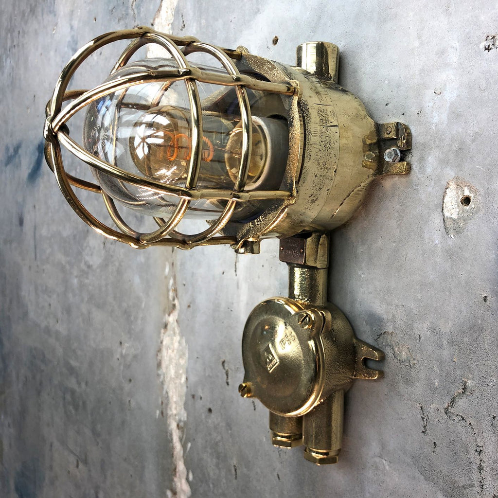 A vintage industrial Wiska industrial brass wall light with a protective brass wire cage & junction box.  