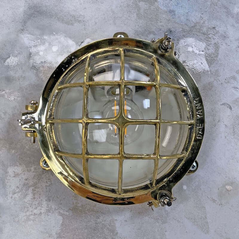 Shop our vintage brass wall sconce reclaimed from the marine industry. The circular bulkhead is professionally restored and compatible with LED light bulbs. We ship worldwide. 