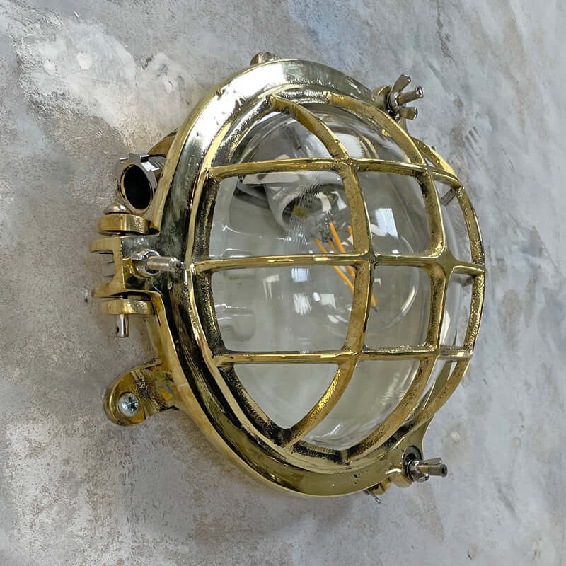 Shop our vintage brass wall sconce reclaimed from the marine industry. The circular bulkhead is professionally restored and compatible with LED light bulbs. We ship worldwide. 