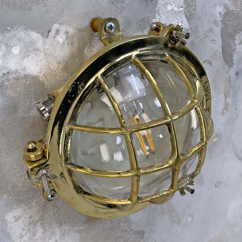 Shop our vintage brass wall sconce reclaimed from the marine industry. The circular bulkhead is professionally restored and compatible with LED light bulbs. We ship worldwide. 