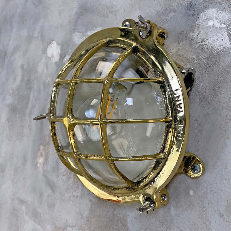 Shop our vintage brass wall sconce reclaimed from the marine industry. The circular bulkhead is professionally restored and compatible with LED light bulbs. We ship worldwide. 