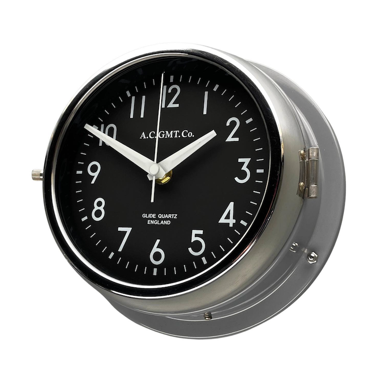 Silver wall clock with black face and white digits. This original nautical wall clock features a quartz silent sweep seconds hand movement meaning no ticking! a timeless and silent wall clock suitable for any contemporary interior. 