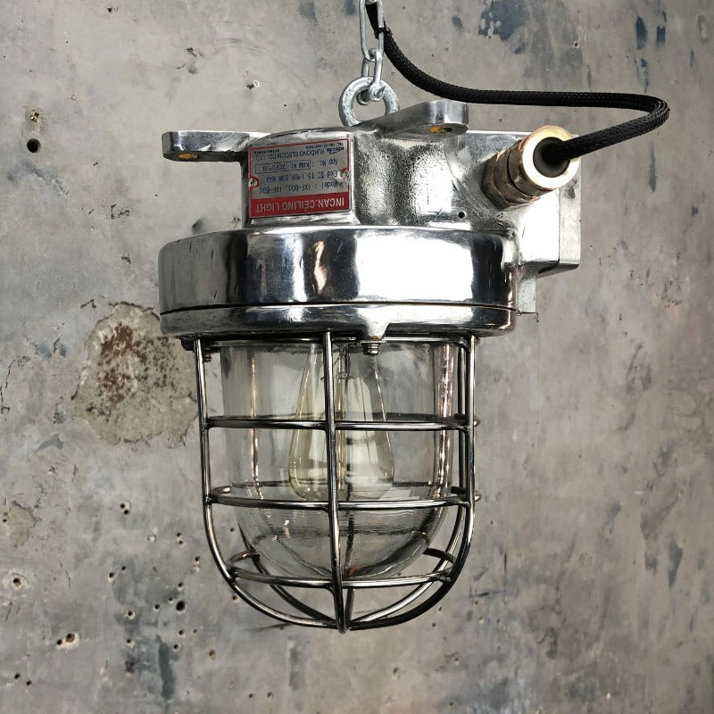 A late century  industrial cast aluminum ceiling light with explosion proof glass dome and cage by Kukdong Elecom