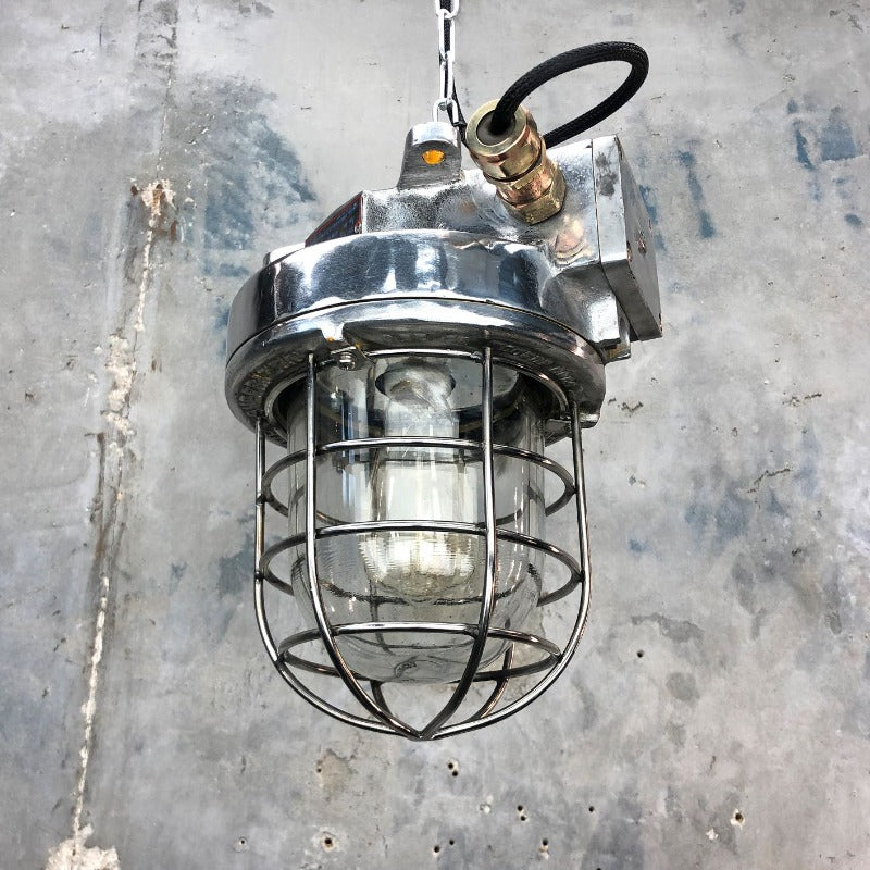 A late century  industrial cast aluminum ceiling light with explosion proof glass dome and cage by Kukdong Elecom