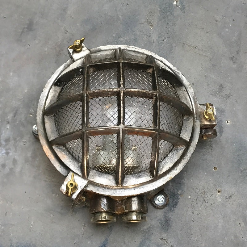 A reclaimed nautical circular solid cast aluminium bulkhead with brass fittings. 
