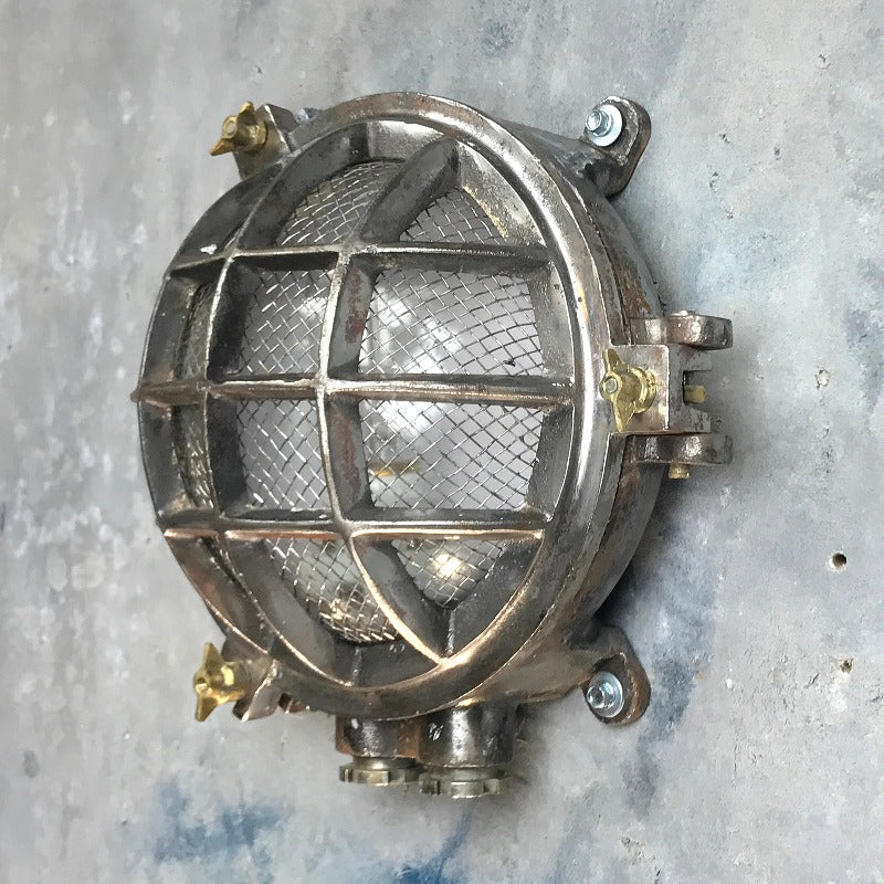 A reclaimed nautical circular solid cast aluminium bulkhead with brass fittings