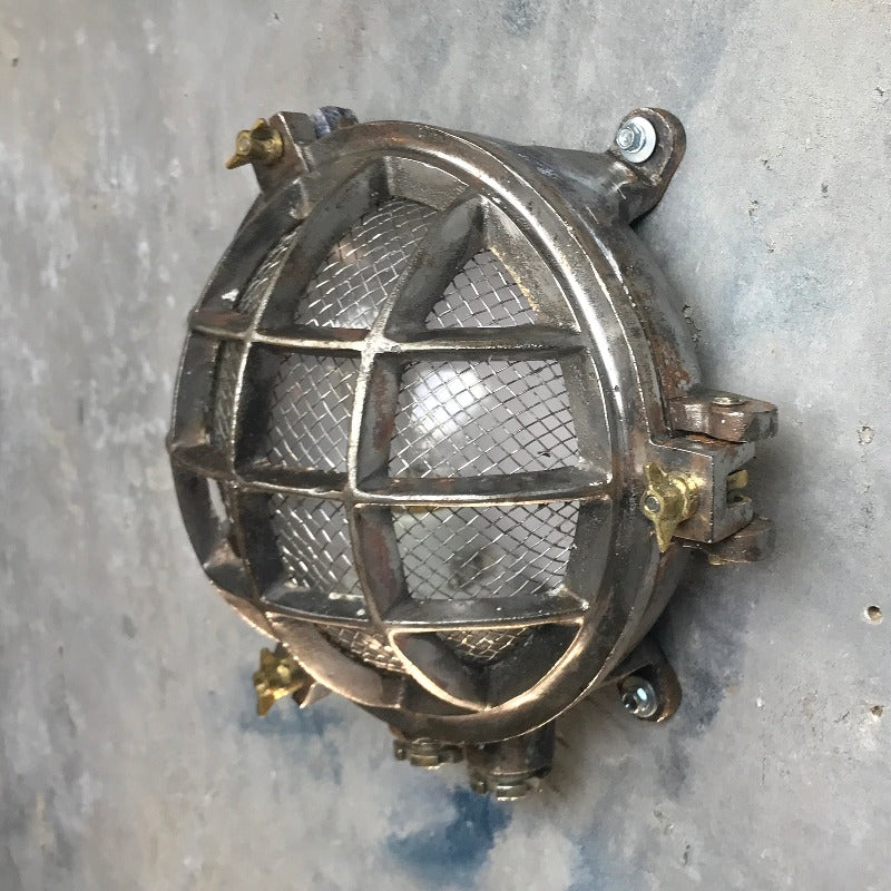A reclaimed nautical circular solid cast aluminium bulkhead with brass fittings