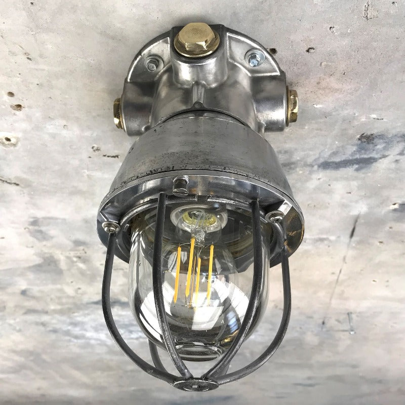 A vintage industrial Italian explosion proof surface mounted ceiling cage light.