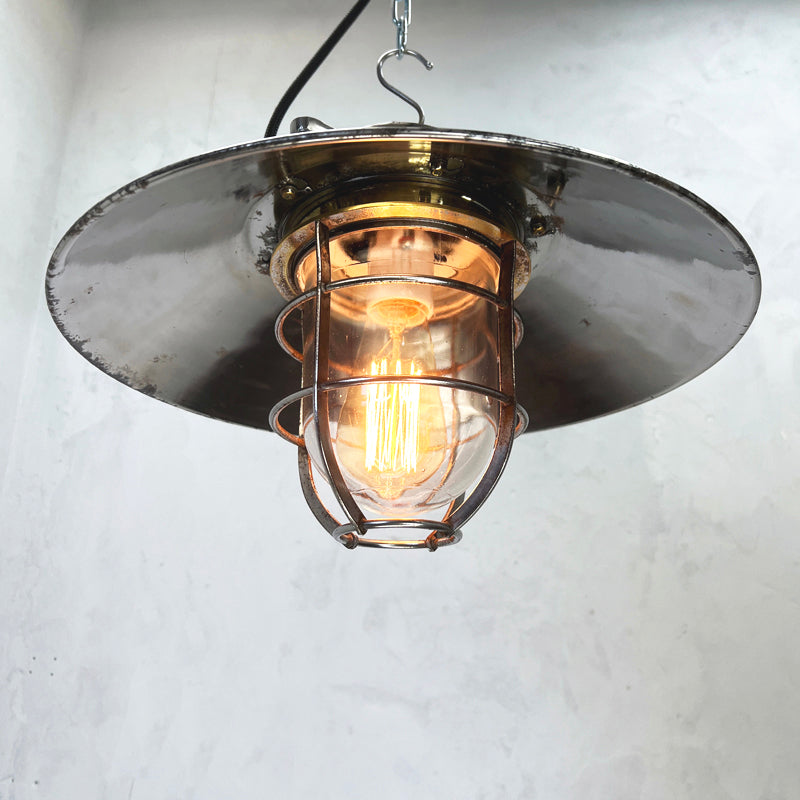 Vintage industrial cage ceiling light made from cast steel with LED filament light bulb. professionally refurbished by British lighting restoration specialists Loomlight.