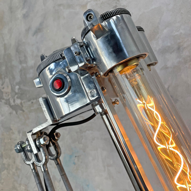 steampunk style aluminium floor lamp with tripod legs and Edison filament LED light bulbs in flameproof glass tubes