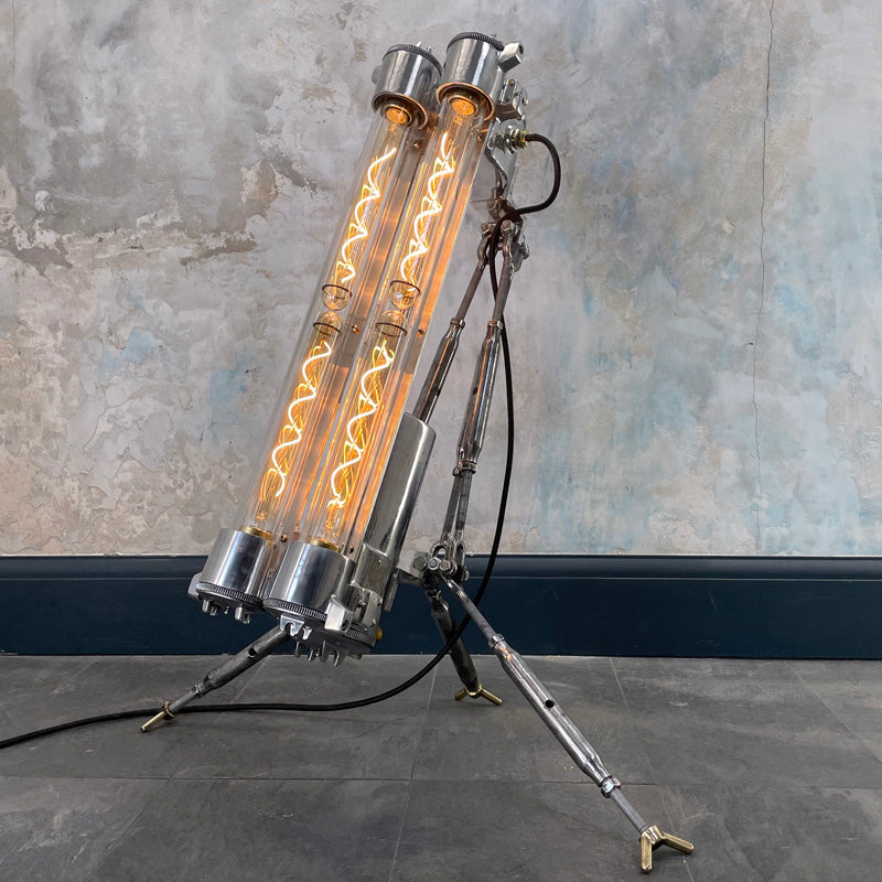 steampunk style aluminium floor lamp with tripod legs and Edison filament LED light bulbs in flameproof glass tubes