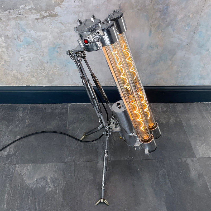 steampunk style aluminium floor lamp with tripod legs and Edison filament LED light bulbs in flameproof glass tubes