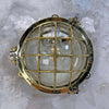 Shop a vintage brass marine bulkhead which is restored by hand by Loomlight in UK. Original Daeyang lighting ready for modern interior. It has a circular brass design and brass cage protecting the glass dome. 