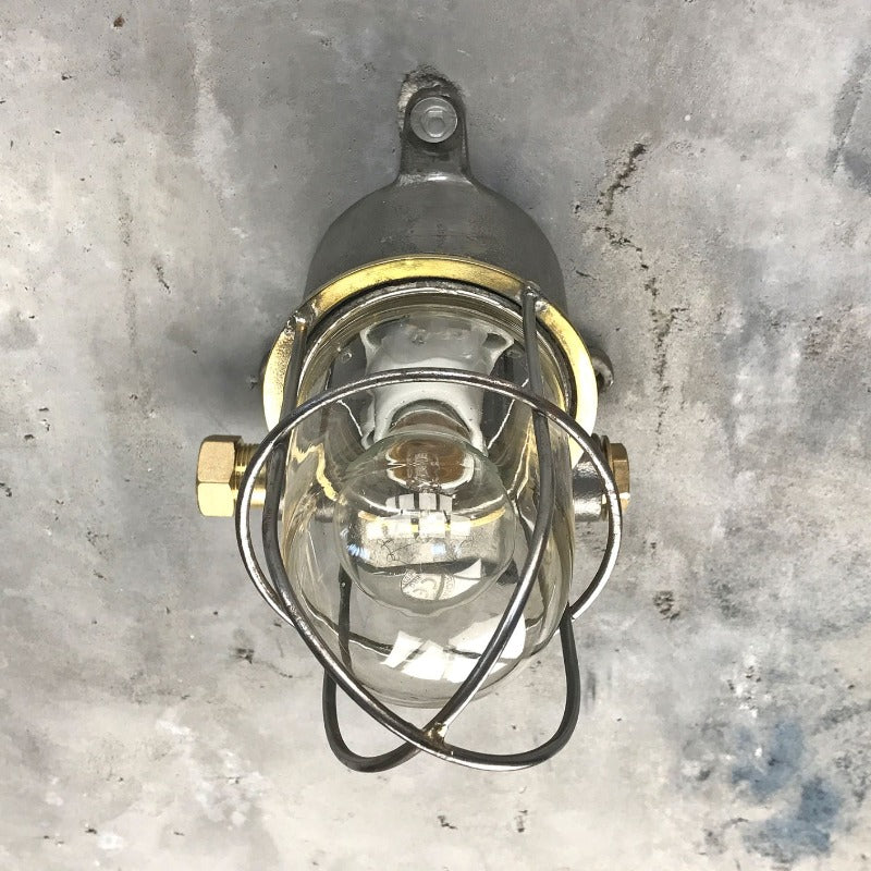 A reclaimed vintage industrial explosion proof outdoor iron wall light with cage, made c1970.